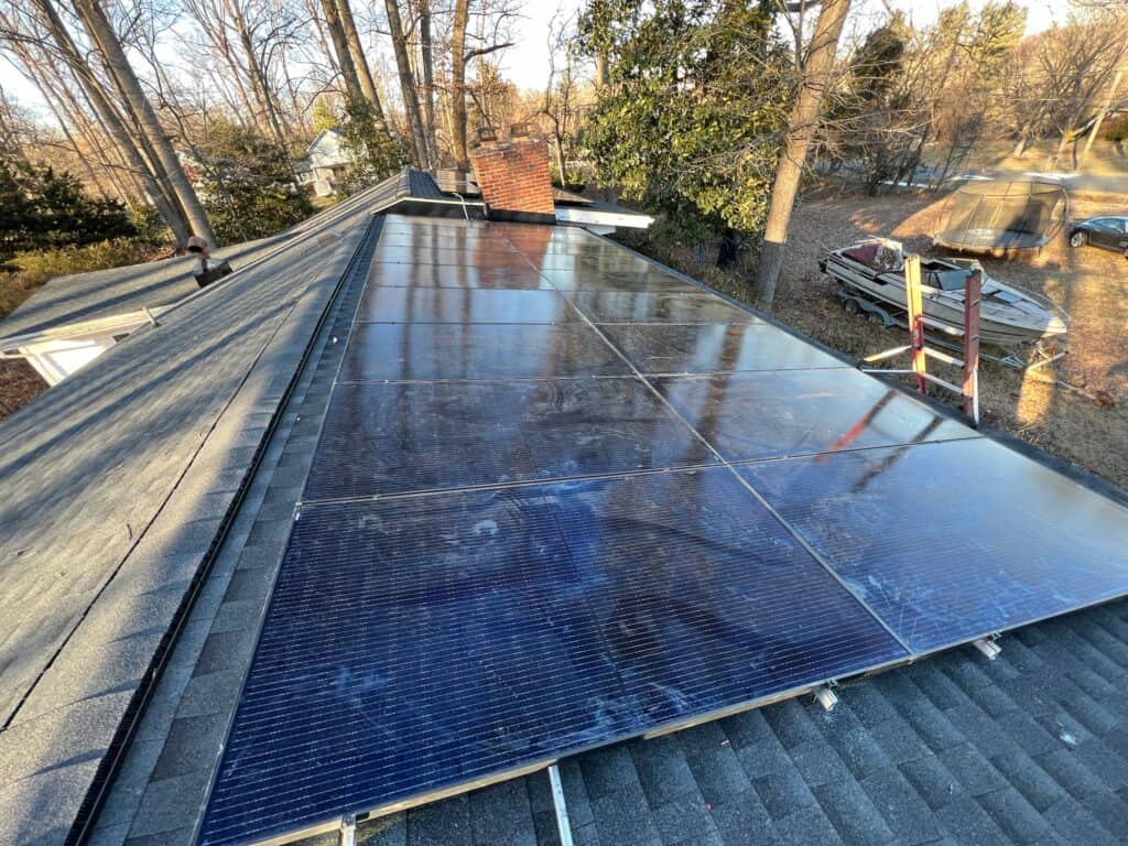 Professional solar panel installer in Annapolis, MD setting up rooftop solar systems for waterfront homes