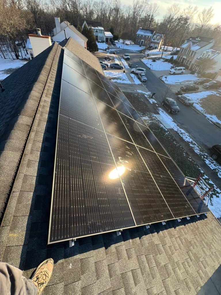 Professional solar panel installer in Baltimore City, MD fitting rooftop solar panels for residential homes